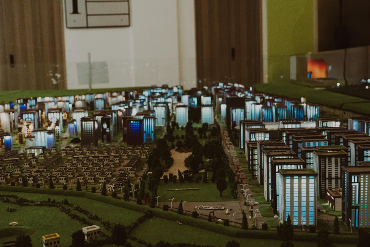 Miniature city model with buildings and trees.