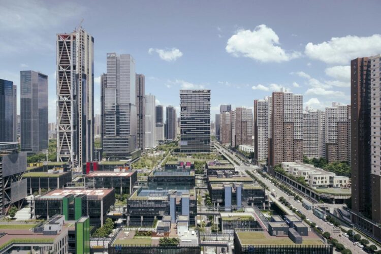 Modern city skyline with tall buildings and blue sky.