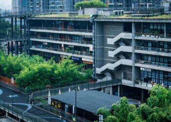 Modern building with green rooftop and bamboo plants